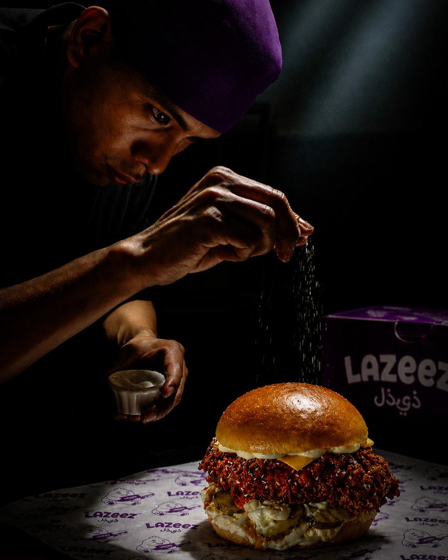 Customer reacting excitedly to a Lazeez burger